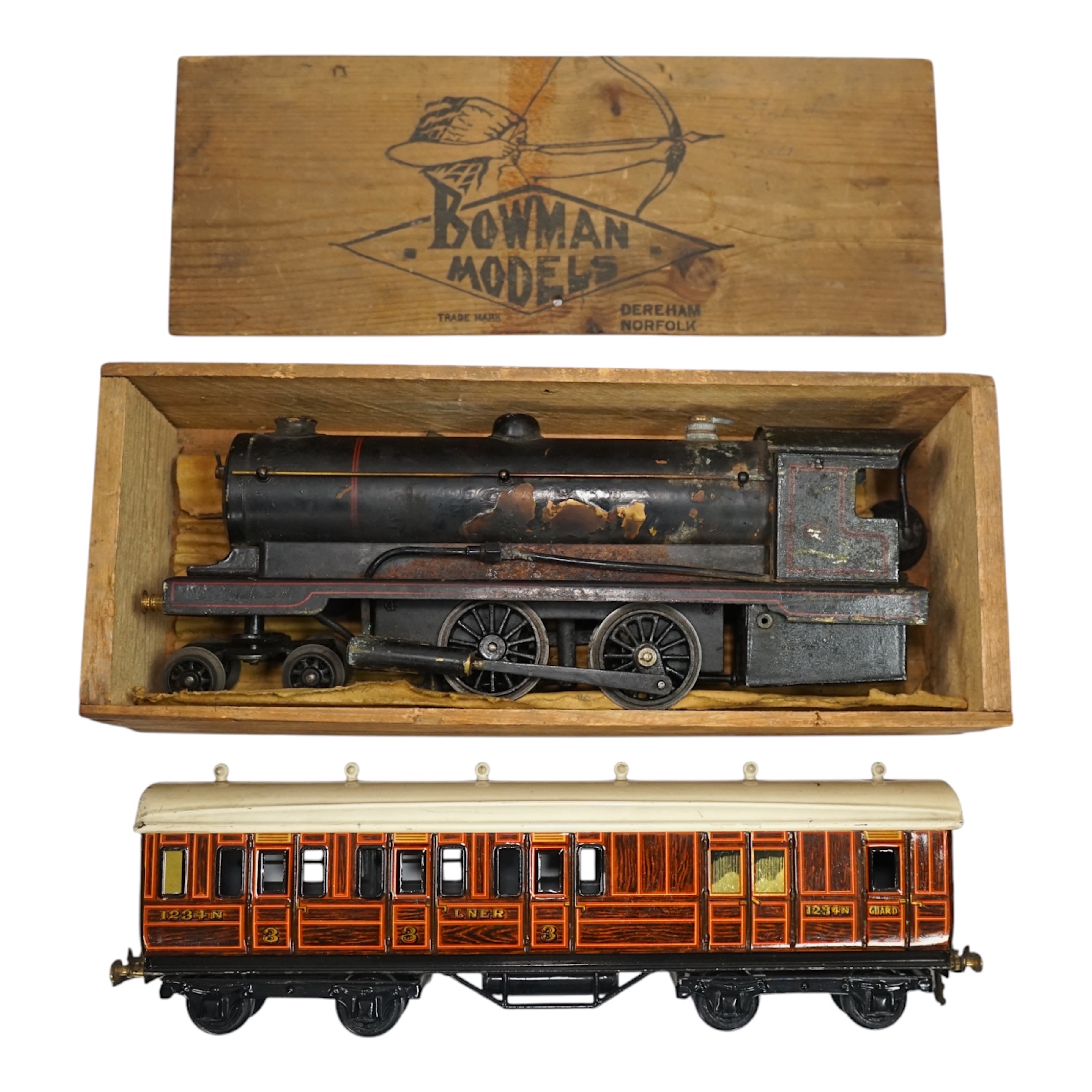 A wooden boxed Bowman Models live steam spirit fired 0 gauge 4-4-0 tender locomotive (without tender), loosely styled in black LNWR livery, together with a tinplate 0 gauge Bing for Bassett Lowke LNER teak bogie coach, 1